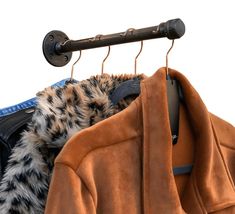 a coat hanging on a clothes rack next to another coat