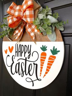 a happy easter door hanger with carrots and greenery hanging on the front door