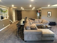 a living room filled with furniture and a flat screen tv mounted to the side of a wall