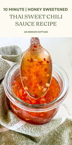 a spoon full of soup sitting on top of a glass bowl