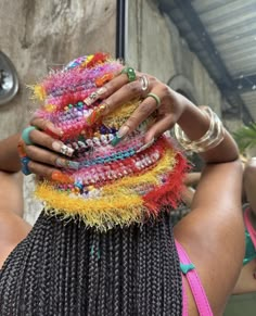 a woman is holding several bracelets in her hands