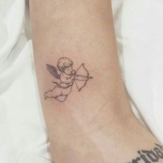 a small cupid angel tattoo on the ankle