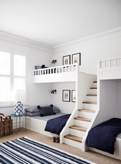 a bedroom with bunk beds and stairs in it