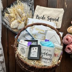 a basket filled with lots of different items on top of a wooden table next to flowers