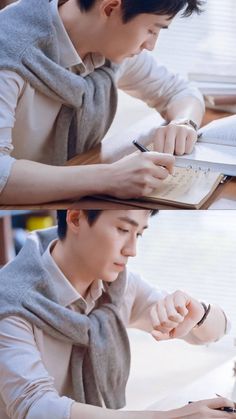 a man sitting at a desk writing on a notebook