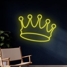 a neon crown on the wall next to a chair