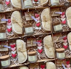 many small boxes filled with different types of candles and cookies in them, all decorated like hearts