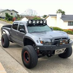 a silver truck parked on top of a street