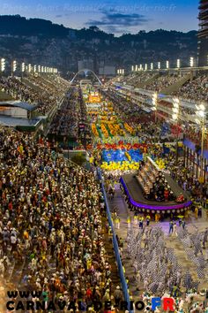 a large group of people standing in front of a crowd at a convention or festival