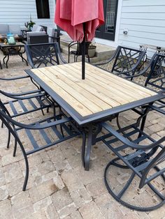 an outdoor table and chairs with an umbrella