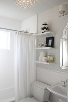 a bathroom with a toilet, sink and bathtub