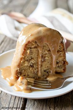 a piece of cake on a plate with a fork and caramel drizzle