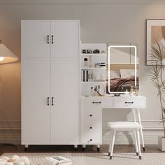 a bedroom with white furniture and a large mirror on the wall