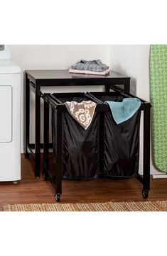 an ironing board and laundry hamper in a room