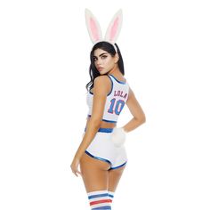 a woman in bunny ears and shorts posing for the camera with her hands on her hips