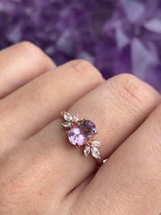 The immaculate vibes of our Contessa Ring are absolutely unmatched. ✨ The pristine and opulent amethyst crystal is framed by two delicate cubic zirconia blossoms in this delicate design. Delicate and regal, unique yet versatile, the Contessa Ring is a unique and stunning addition to any jewelry collection. 💜 * * * Don't know your ring size? View our Ring Size Guide * * * …………………………………. RING SIZE & MATERIAL❋ 18k rose gold plated sterling silver❋ cubic zirconia crystals❋ 6x8mm natural amethyst cr Amethyst Wedding Rings Gold, Cristal Engagement Ring, Purple Sapphire Engagement Ring Stacking, Gold Ring With Amethyst, Rings Engagement Amethyst, Purple Gem Engagement Ring, Amathus Ring, Gold Amethyst Engagement Ring, Engagement Rings With Crystals