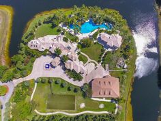 an aerial view of a large estate with a pool and tennis court in the foreground