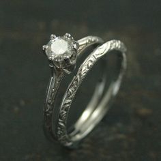 two wedding bands with a diamond in the center