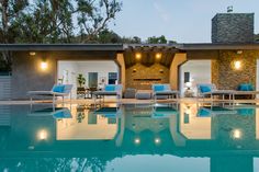 Beverly Hills mansion architectural design opens the indoor living spaces up to the outdoor luxury pool & terrace with sliding glass walls. Beverly Hills Mansion, Swimming Pool Photos