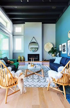 a living room filled with furniture and a dog standing in front of the couches