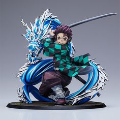 an action figure is posed on top of a blue and white dragon figurine