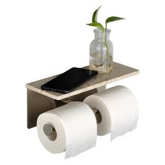 two rolls of toilet paper sitting on top of a wooden table next to a vase with a plant