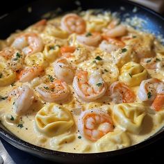 a skillet filled with pasta and shrimp