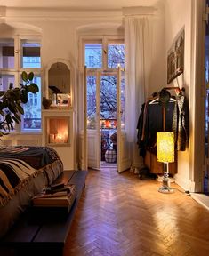 a bedroom with hardwood floors and white walls