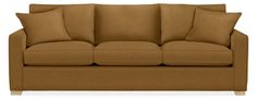 a brown couch with four pillows on it