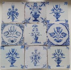 several blue and white tiles with designs on them