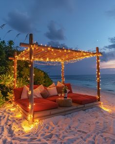 an outdoor seating area with lights on the beach