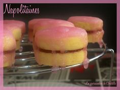 pink and yellow donuts with icing on a wire rack in front of the caption napapotanes