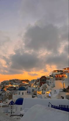 the sun is setting over some white buildings