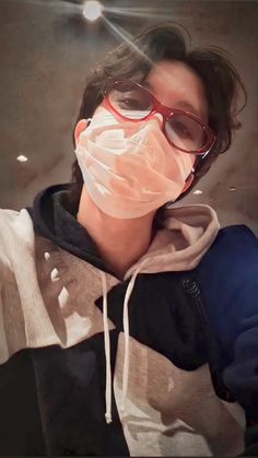 a person wearing glasses and a mask