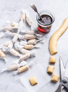 some food is laying out on the table next to a knife and fork with sauce in it