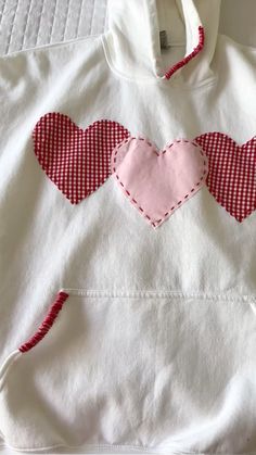 a white shirt with two hearts on it