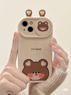 a person holding up a cell phone case with an image of a bear on it