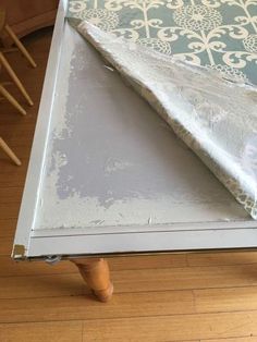 a piece of furniture that has been painted and is sitting on top of a hard wood floor