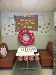 a table with donuts on it and a sign that says we do not want to see you go