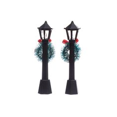 two christmas wreaths are on top of black posts with red and blue pom - poms