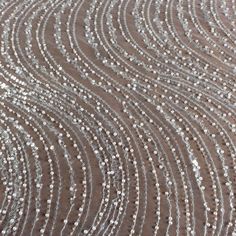 a close up view of the fabric with silver sequins on it, as well as some white dots