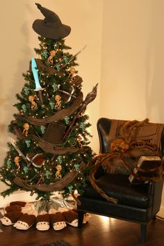 a decorated christmas tree sitting next to a black chair