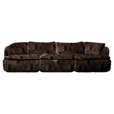 a brown and black couch sitting on top of a white floor