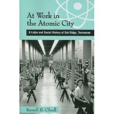 a book with an image of people working in the atomic city, and text that reads at work in the atomic city