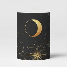 a black candle with gold stars and a crescent on it