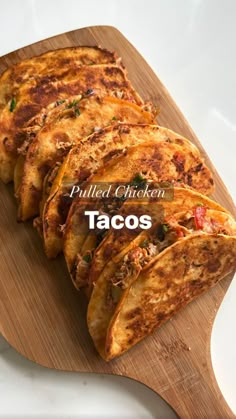 grilled chicken tacos on a cutting board with text overlay that reads pulled chicken tacos