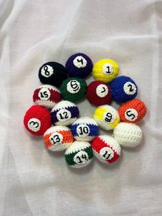 crocheted balls are arranged in the shape of numbers on a white sheet,