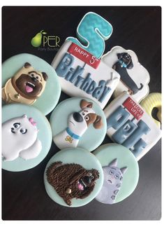 there are many decorated cookies that have dogs and cats on them in the shape of buttons