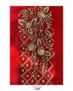 an embroidered red fabric with gold flowers and leaves on the side, along with pearls