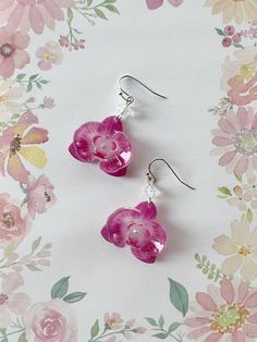 Elevate your style with these Shrink Plastic Pink Purple Orchid Flower with Aurora Crystal Beads Dangled Drop Earrings, a handmade masterpiece that combines the exotic allure of orchid blooms with the captivating sparkle of crystal beads. These earrings are a true celebration of creativity and craftsmanship. Each earring showcases a meticulously designed pink- purple orchid flower, intricately crafted from shrink plastic to capture the intricate details and delicate beauty of these exquisite blo Jocelyn Core, Shrink Plastic Ideas, Shrink Plastic Jewelry, Orchid Jewelry, Orchid Earrings, Pretty Jewelry Necklaces, Phone Photo, Prom Accessories, Diy Jewelry Unique